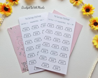 Könnte beinhalten: Zwei weiße Blätter Papier mit schwarzen Umrissen von Hundenäpfen. Das obere Blatt trägt den Text "Pet Savings Challenge" und "Each Bowl = 10 BudgetWithMads Total = 300". Das untere Blatt trägt den Text "Pet Savings Challenge" und "Each Bowl = 10 BudgetWithMads Total = 300".