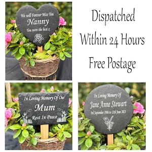 May include: A selection of memorial slate plaques in heart, rectangular, and circular shapes, set in woven baskets with pink flowers. The plaques are engraved with text like "Nanny" and "Mum", and floral designs. The image also includes text that says "Dispatched Within 24 Hours".