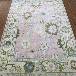 Hand-Knotted Oushak Rug: 8x10 Pink Wool Rug with Cream Border