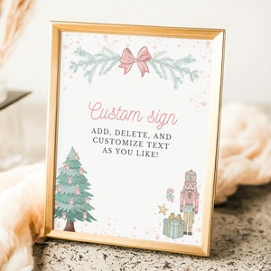 May include: A framed custom sign with a gold border. The sign features a Christmas tree, a nutcracker, and the text "Custom sign". The sign is decorated with a pink bow and sprigs of greenery.