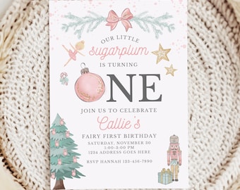 May include: A rectangular birthday invitation card featuring a pink bow, a ballerina, gold stars, a pink ornament, a Christmas tree, and a nutcracker. The text reads: Our little sugarplum is turning one, join us to celebrate Callie's fairy first birthday.