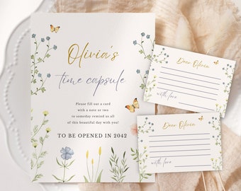May include: A white card with a floral design and gold lettering that says "Olivia's Time Capsule" and "To Be Opened in 2042". Two smaller cards with lines for writing messages say "Dear Olivia" and "with love".