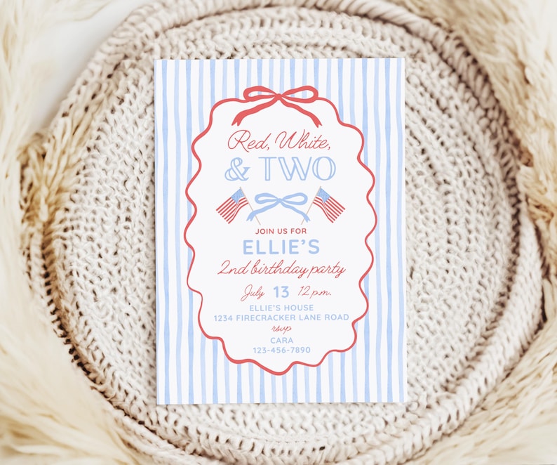 May include: A rectangular birthday party invitation card with a light blue vertical striped background. The center features a red scalloped frame with a bow, two small American flags, and text reading Red, White, & TWO, Ellie's 2nd birthday party, July 13 12pm, Ellie's house, 1234 Firecracker Lane Road, and contact details.
