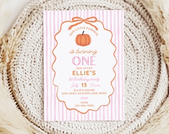 May include: A rectangular birthday invitation card with a light pink and white vertical striped background. The center features a scalloped orange frame with a bow at the top, containing an orange pumpkin graphic and text detailing a first birthday party.