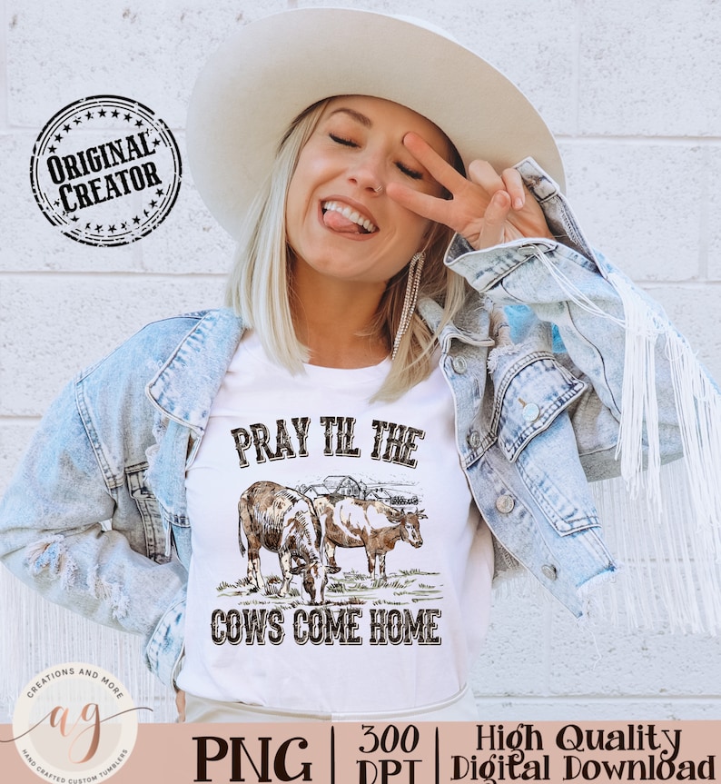 May include: A white t-shirt with a brown and white illustration of two cows and the text "Pray Til The Cows Come Home".