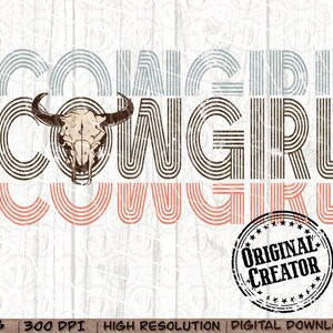 May include: Cowgirl graphic design with a cow skull in the center. The text is in a retro style with brown, pink, and blue stripes. The text reads "Cowgirl Cowgirl". A distressed black circle stamp reads "Original Creator".