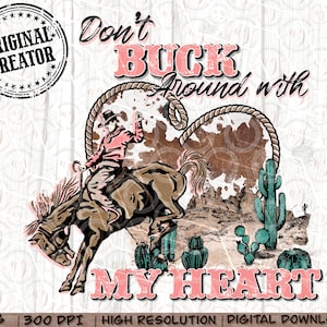 May include: A digital graphic with a cowboy riding a bucking bronco, set against a desert landscape and a heart-shaped cowhide design. Text reads "Don't Buck Around with My Heart" in pink. Includes cactus and mountains.
