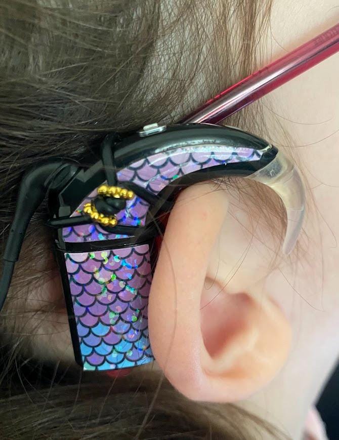 Cochlear implant and hearing aid holder to attach to glasses