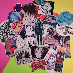 May include: A selection of vibrant stickers showcasing diverse illustrations, such as anime characters, creatures, and abstract art. The stickers display a spectrum of colours, including pink, yellow, blue, and red. Some stickers feature text, including "HUNGRY" and "KIL".