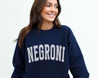 May include: A navy blue sweatshirt with the word "NEGRONI" printed in white on the front.