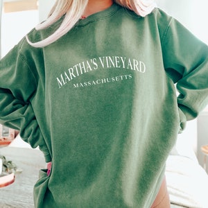 May include: A green sweatshirt with the text "Martha's Vineyard Massachusetts" in white.