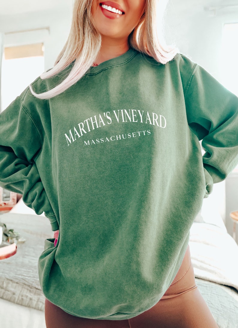 May include: A green sweatshirt with the text "Martha's Vineyard Massachusetts" in white.