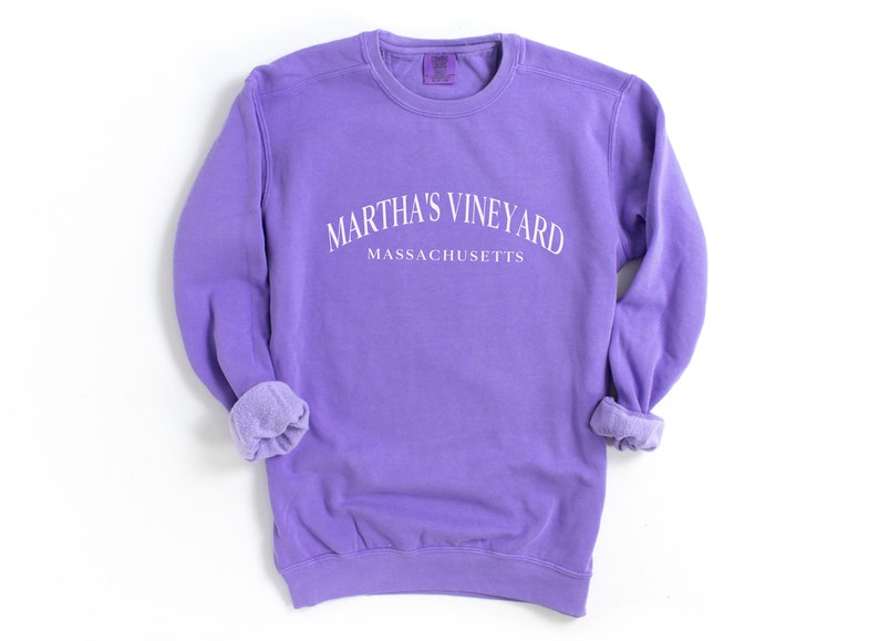 May include: Purple sweatshirt with the text "Martha's Vineyard Massachusetts" in white.