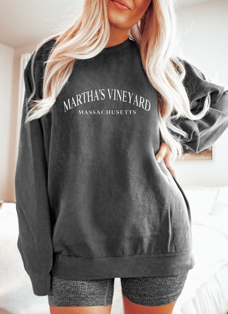May include: A dark grey sweatshirt with the text "Martha's Vineyard Massachusetts" printed on the front.