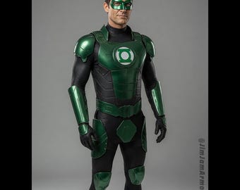 Puede incluir: Un disfraz de Green Lantern que presenta una placa pectoral de color verde metálico con un emblema circular blanco, hombreras, antebrazos y protectores de piernas a juego, una máscara verde y un traje base de color negro.