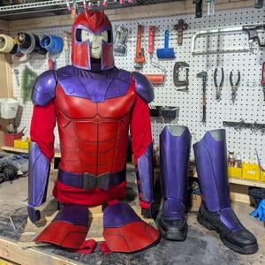 May include: A full-body costume set featuring a red and purple helmet, chest plate, shoulder guards, arm bracers, thigh plates, and shin guards with black boots. The armor pieces are constructed with a smooth finish and vibrant color scheme.
