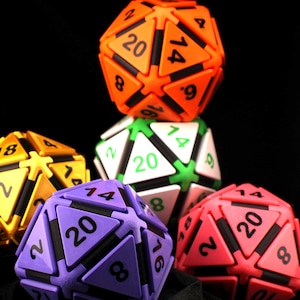 May include: A collection of colorful, multi-sided dice in various colors, including orange, green, purple, yellow, and red. Each die has numbers from 1 to 20. The dice are arranged against a black background.