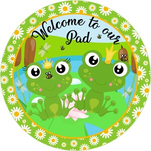 May include: Welcome to our Pad sign with two green frogs wearing crowns and sitting on lily pads. The sign is surrounded by a white daisy border on a green background.