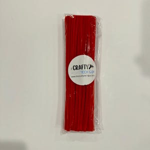 May include: A package of red pipe cleaners. The package is labeled "The Crafty Tech Guy" and includes the website address "www.thecraftytechguy.com".