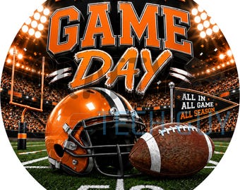May include: A circular graphic featuring the text GAME DAY in orange and black letters above an orange football helmet and a brown football on a green field. A small black pennant flag displays the text ALL IN ALL GAME ALL SEASON.