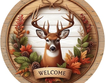 May include: A round wooden sign with a rustic, distressed finish. A deer head with antlers is in the center of the sign, surrounded by a wreath of fall leaves and pine cones. The sign says "WELCOME" in a banner.
