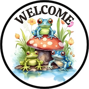 May include: A round welcome sign with a black border and white background. The word "WELCOME" is written in black letters around the edge of the sign. Three frogs are sitting on a red and white mushroom. The frogs are green, blue, and green with red eyes.