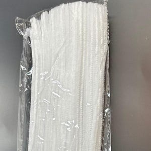 May include: A package of white pipe cleaners. The pipe cleaners are bundled together and wrapped in clear plastic.