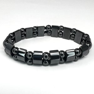 May include: A black hematite bracelet with round and rectangular beads.