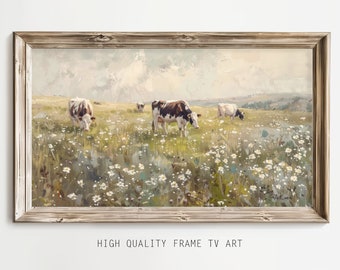 May include: A framed painting depicting a field of white wildflowers with four black and white cows grazing. The sky is a light blue with white clouds.