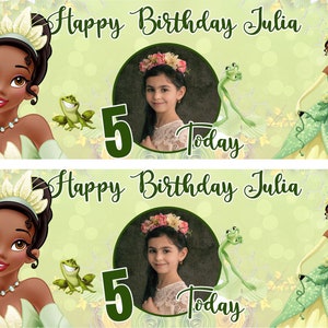 May include: Green and yellow birthday banner featuring a photo of a girl in the centre. The banner reads "Happy Birthday Julia" and "Today" and includes a number 5. There are also images of a frog and a princess.