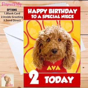May include: A birthday card featuring a brown dog wearing a red shirt with the name "AVA" on it. The card has a yellow background with paw prints and the text "HAPPY BIRTHDAY TO A SPECIAL NIECE 2 TODAY".