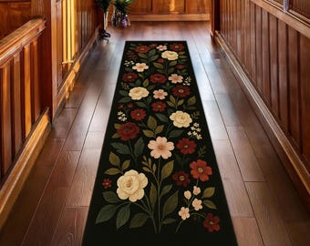 Elegante alfombra floral para pasillo: alfombra negra con diseño botánico en rojo, blanco y rosa para la decoración del hogar.