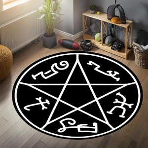 Puede incluir: Alfombra de pentagrama en blanco y negro con las palabras "Asmodeo", "Leviatán", "Belcebú", "Lucifer" y "Samael" escritas alrededor del perímetro.