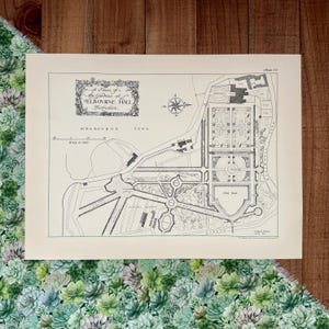 May include: A black and white architectural print of the gardens at Melbourne Hall, Derbyshire. The print includes a compass rose, a scale of feet, and the text "Public Hemp". The print is on a cream-colored paper.
