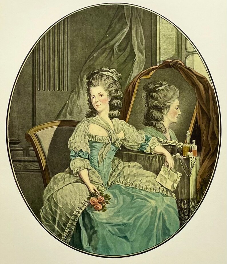 May include: A woman in a blue and white dress sits in a chair, looking at her reflection in a mirror. She holds a bouquet of pink roses in her lap. The mirror is draped with a red cloth and there are bottles of perfume on the table.