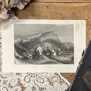 May include: A black and white engraving of a mountain landscape with figures in the foreground. The engraving is titled "The Collectable Mountains".