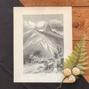 May include: A black and white illustration of a mountain range with a wagon train traveling through a pass. The text "Pilot Knob" is printed at the bottom of the image.