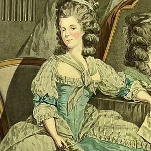 May include: A woman in a light blue and white dress with a ruffled neckline and a white bow at the neck. She is holding a bouquet of pink roses in her hand. The woman is sitting in a chair with a green background.