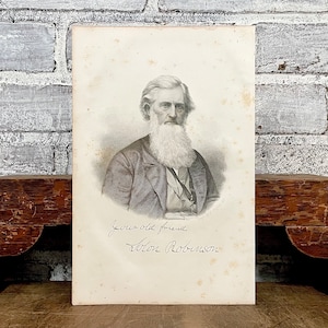 May include: A black and white portrait of a man with a long beard and mustache. He is wearing a dark suit and a tie. The portrait is signed "Your old friend,  Abram Robinson."