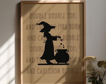 May include: A framed print with a brown background featuring a black silhouette of a witch stirring a cauldron with the text "Double double toil and trouble fire burn and cauldron bubble".