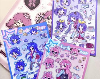 May include: A collection of colorful anime-style sticker sheets. The stickers feature various characters with large eyes and vibrant hair, in shades of blue, pink, and purple. Some sheets have the text "Lucky Star".