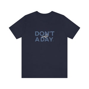 May include: A navy blue t-shirt with the text "DON'T waste A DAY" printed in light blue.