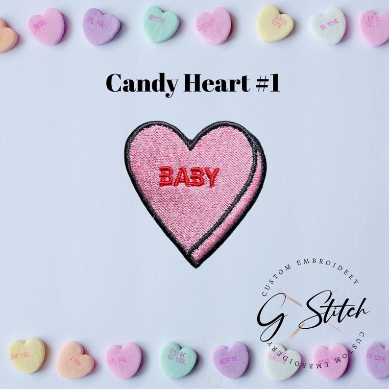 May include: A pink embroidered heart-shaped patch with the word "BABY" in red. The patch has a black border and is labelled "Candy Heart #1". Pastel candy hearts with phrases like "BESTIE" and "BE MINE" surround the patch.