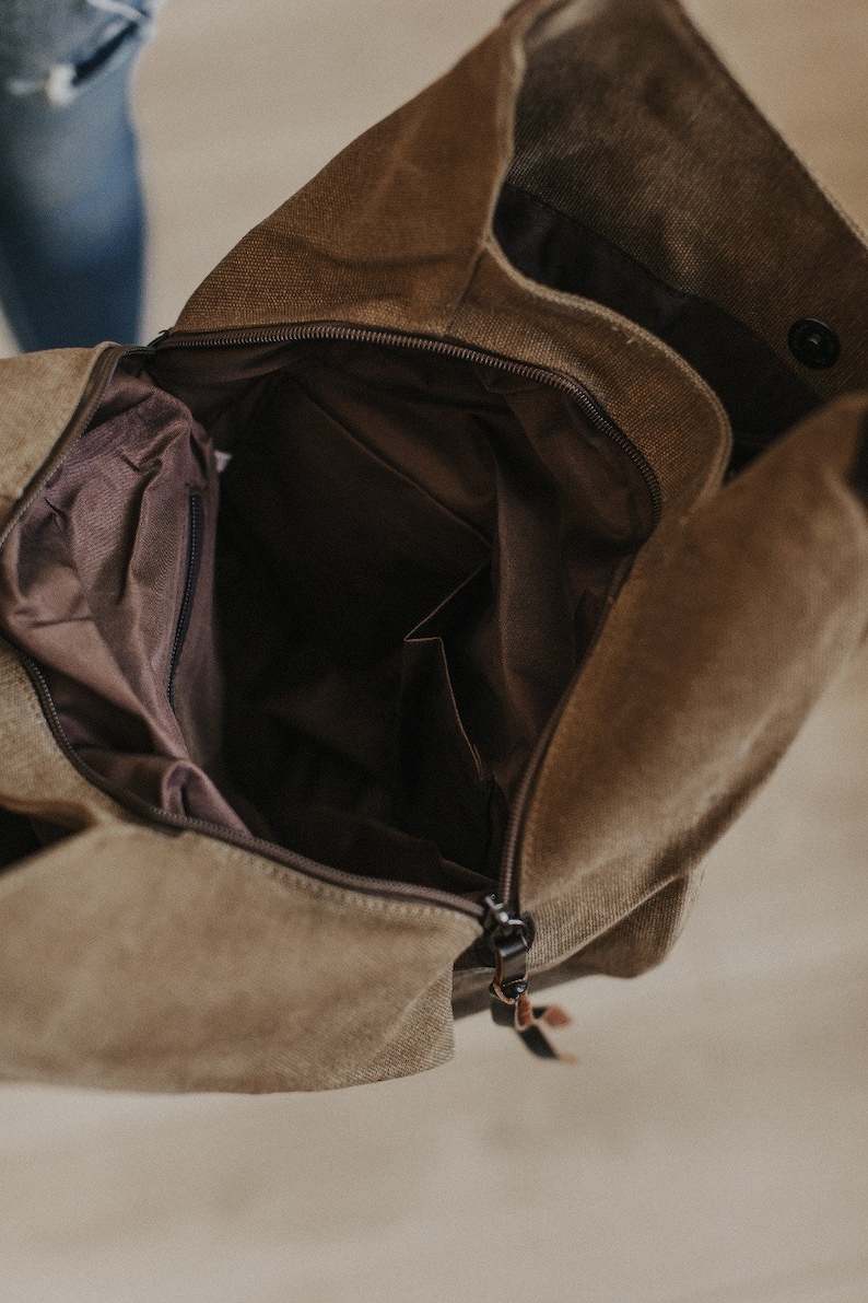 An interior shot of a canvas hobo bag showing the two sections and middle zipper.