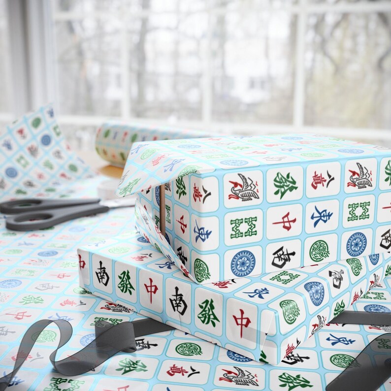 Flat image of unrolled 24 in x 60 in wrapping paper with white Mahjong tiles on a light blue background.