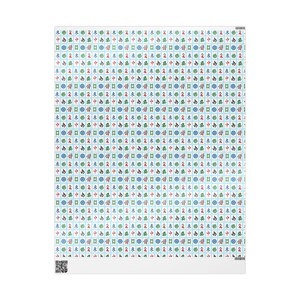 Close up of wrapping paper with white Mahjong tiles on a light blue background. There are also green and gold ribbons and the side of a white box.