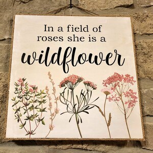 in a field of roses, she is a wild flower - JAW Signs Designs