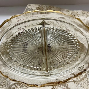 May include: A divided glass serving dish with a gold rim. The dish has a diamond pattern and is perfect for serving snacks or appetizers.