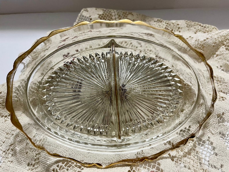 May include: A divided glass serving dish with a gold rim. The dish has a diamond pattern and is perfect for serving snacks or appetizers.