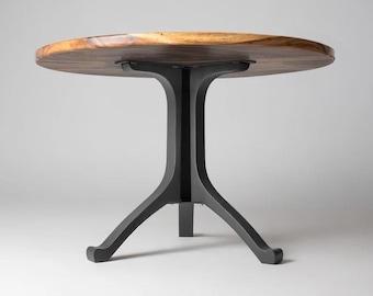 May include: A round wooden table top with a black metal base. The base has three legs that extend out from a central column.